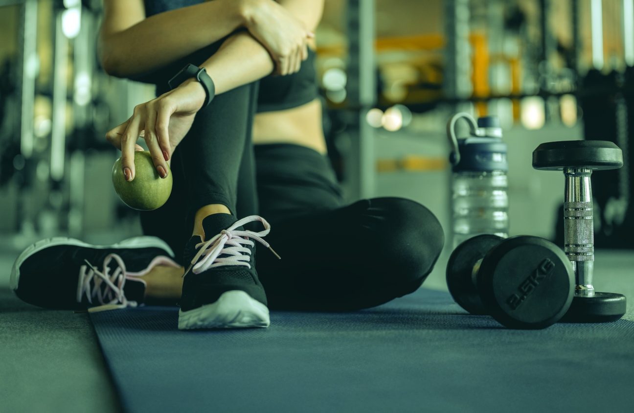 A woman in sports clothing resting after exercise.