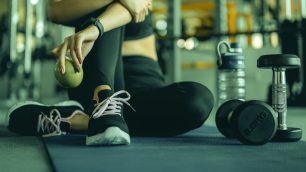 A woman in sports clothing resting after exercise.